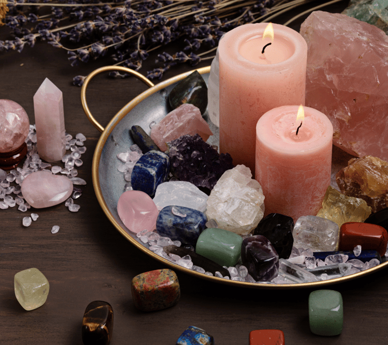 a candle with candles and crystals on a tray