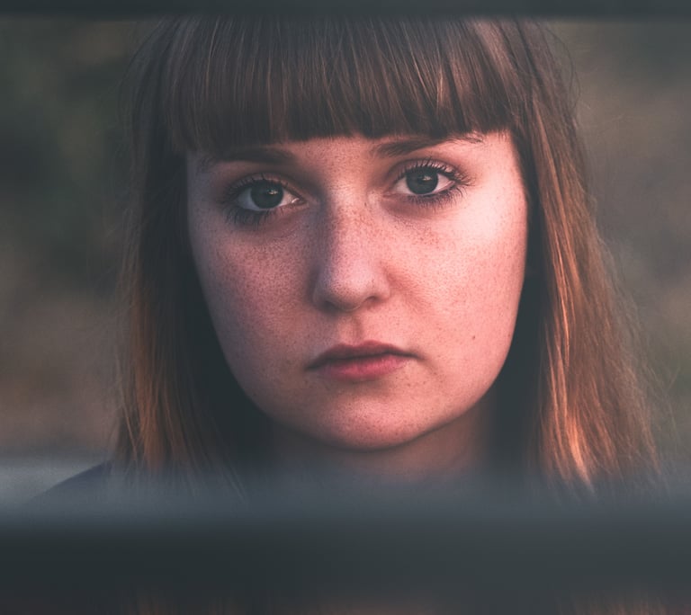 close up of a women with long hair and visible freckles