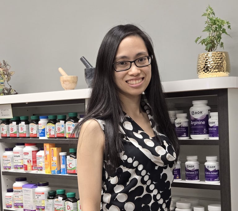 A woman with long black hair and glasses