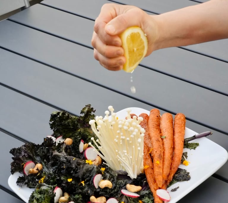 a person squeezing lemonade on a plate of food