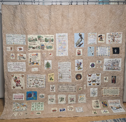 Custom quilt created from cherished counted cross stitch artwork, professionally quilted and arrange