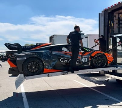 a man is loading a car into a trailer