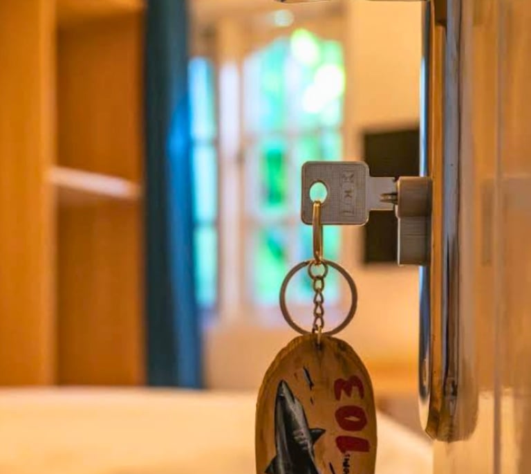 Bright guest room at Scuba Haven Guesthouse in Fuvahmulah, Maldives, with open door and key inside