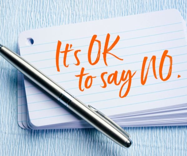 a pen and on a notebook with the words it's ok to say no