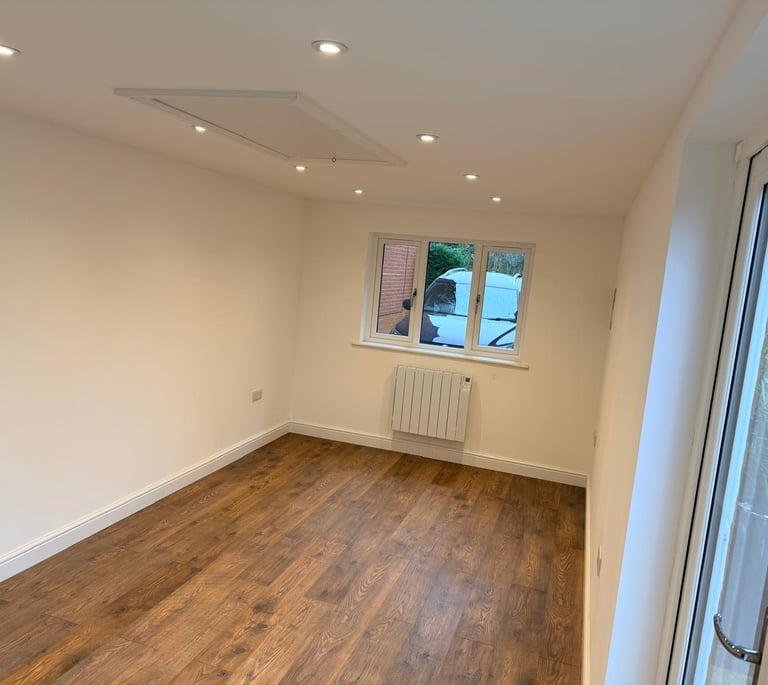 Inside converted garage showing new window to front