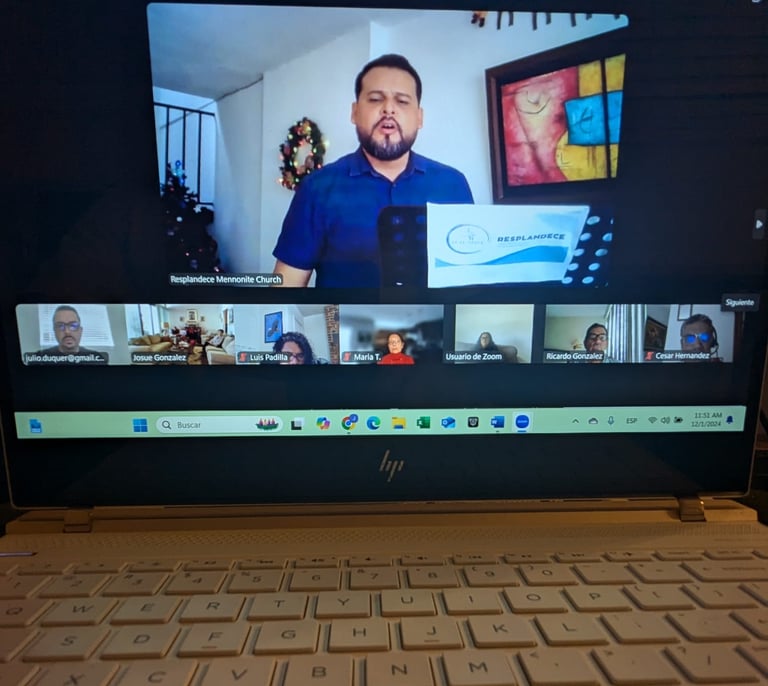 a laptop computer screen showing a video chat with a man on the screen