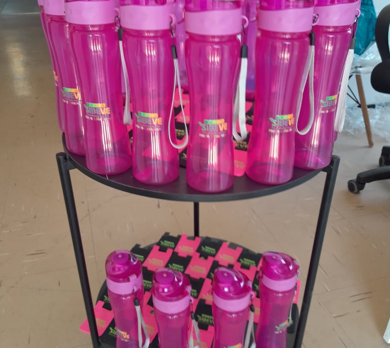 a carton of pink plastic cups and bottles of water branded sibeve