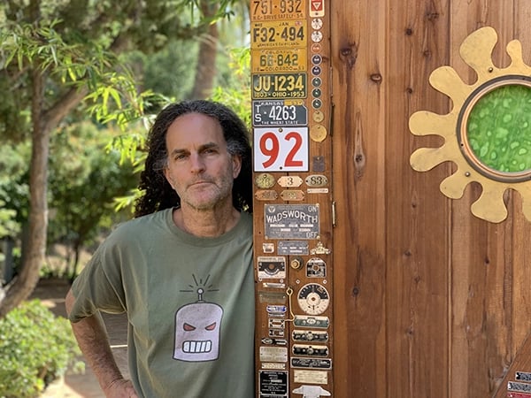 Artist Tal Avitzur standing by his workshop door.