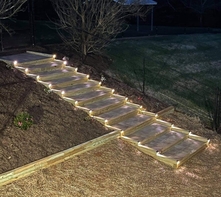 Timber outdoor stairs with landscape lighting installed on hillside in Catawba County NC