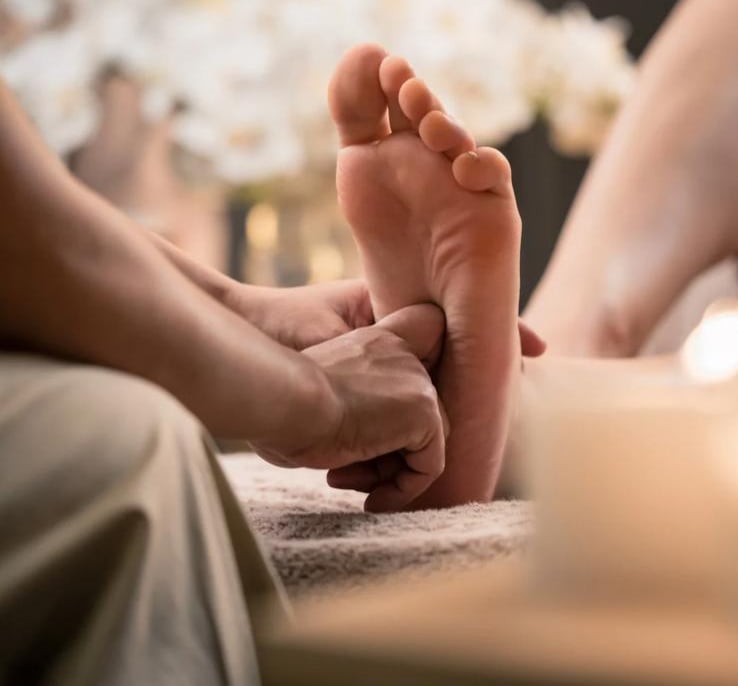 Foot reflexology therapy applying pressure to specific points