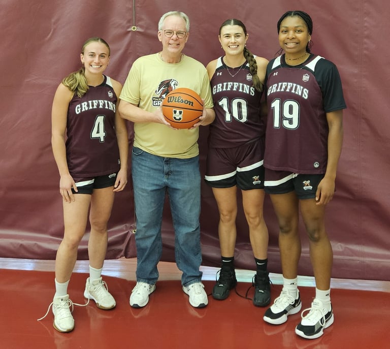 Picture of Allan with Paige, Sofia, and Unity from the MacEwan University Women's Basketball team.