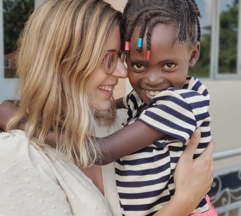 a woman holding a child in her arms