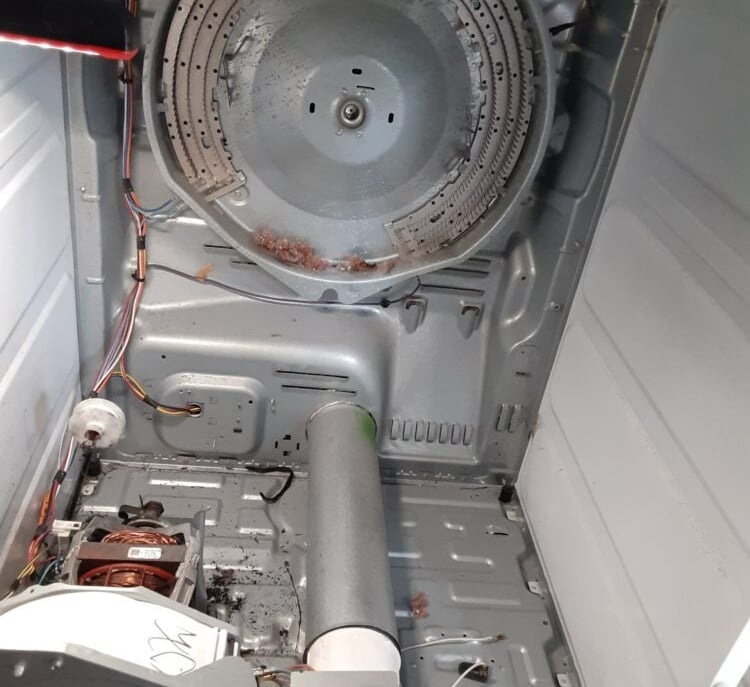 dryer taken a part and showing an exposed heating element