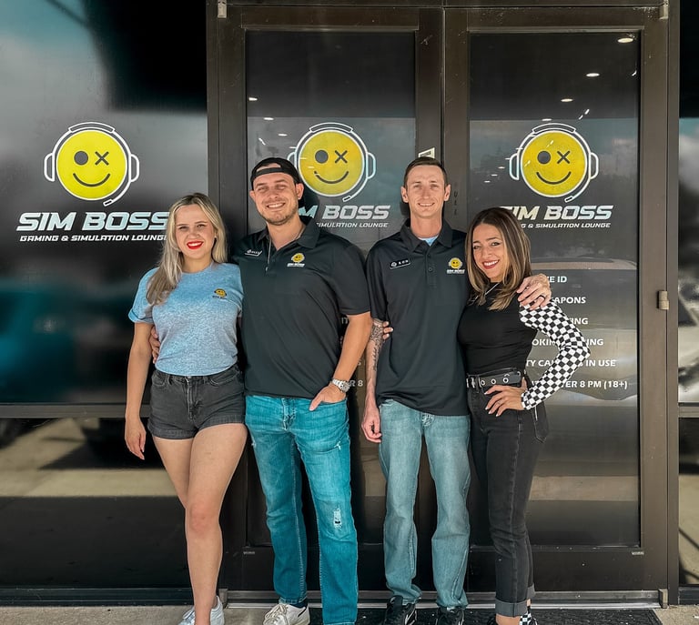 The original owners and creators smiling in front of the entrance of Sim Boss.