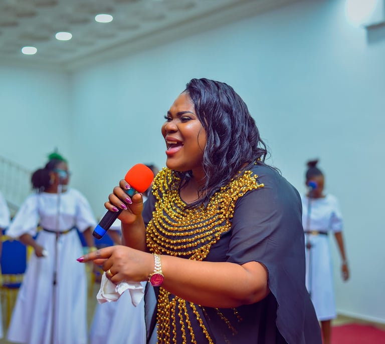 a woman in a black dress and a microphone
