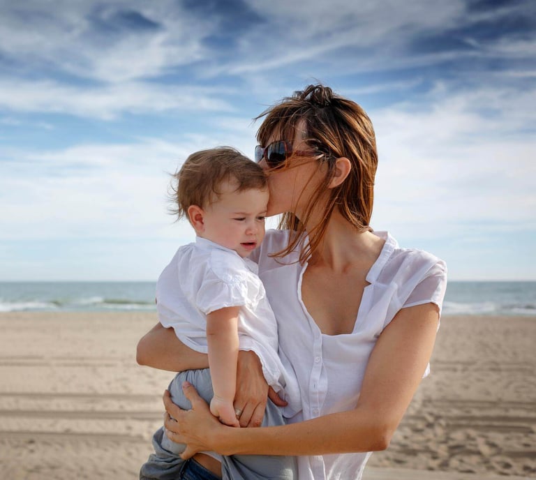 Mother with child on Murcia beach - life insurance for expats protecting families with English-speak
