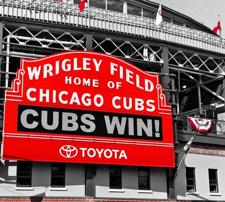 a large red and white sign that says cubs win at wrigley field