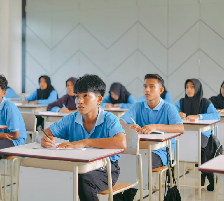 Malaysian students in a classroom prep for SPM and UASA using PNI Neuron visual learning for memory mastery.