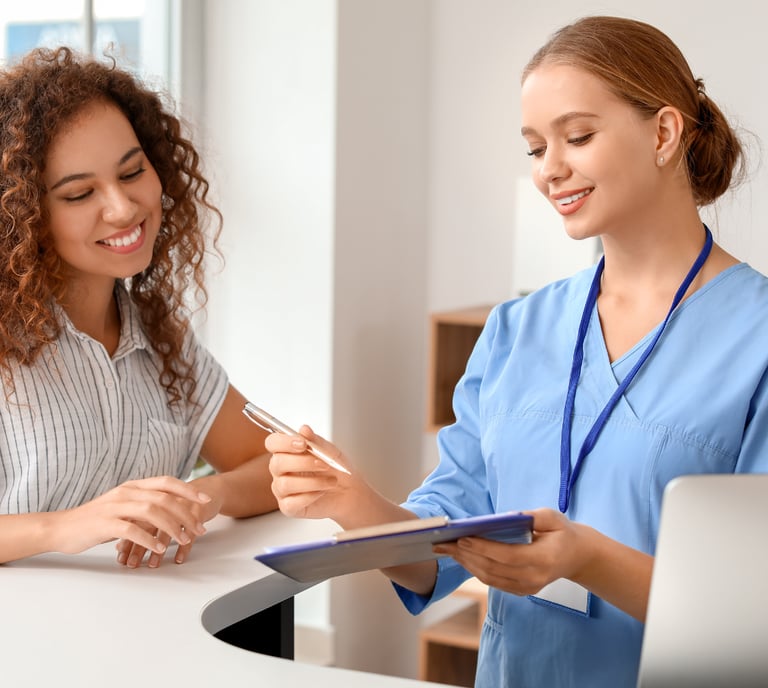 Dental practice front desk with a healthcare administrator and a patient.