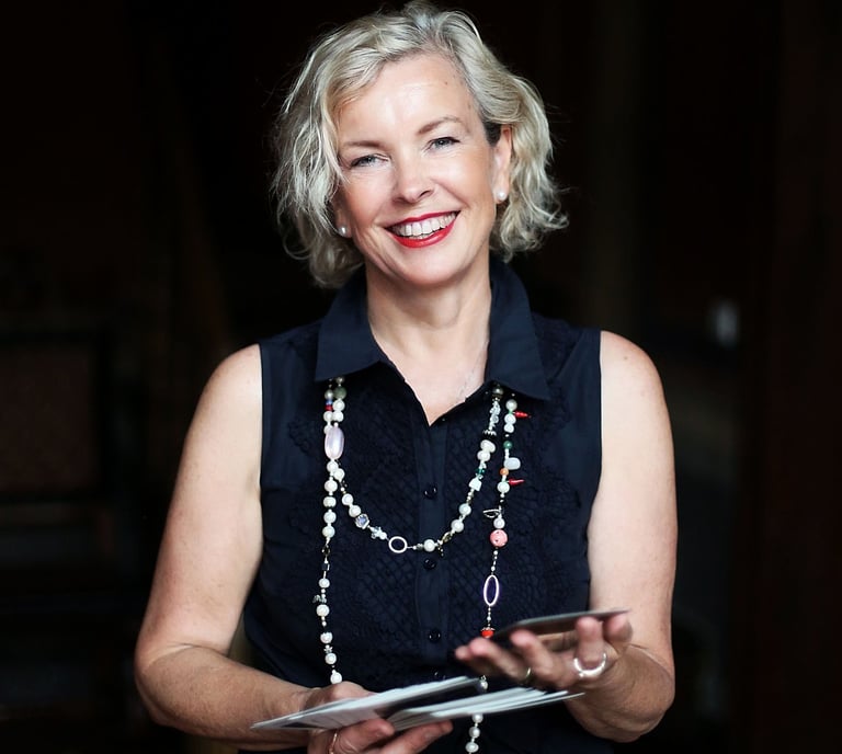 a woman in a black dress and pearls necklaces