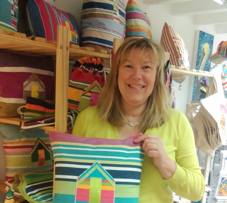 Lesley holding beach hut cushion