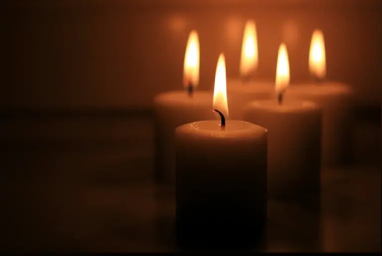 A group of softly glowing candles symbolizes peace, reflection, intuition, and spiritual connection.
