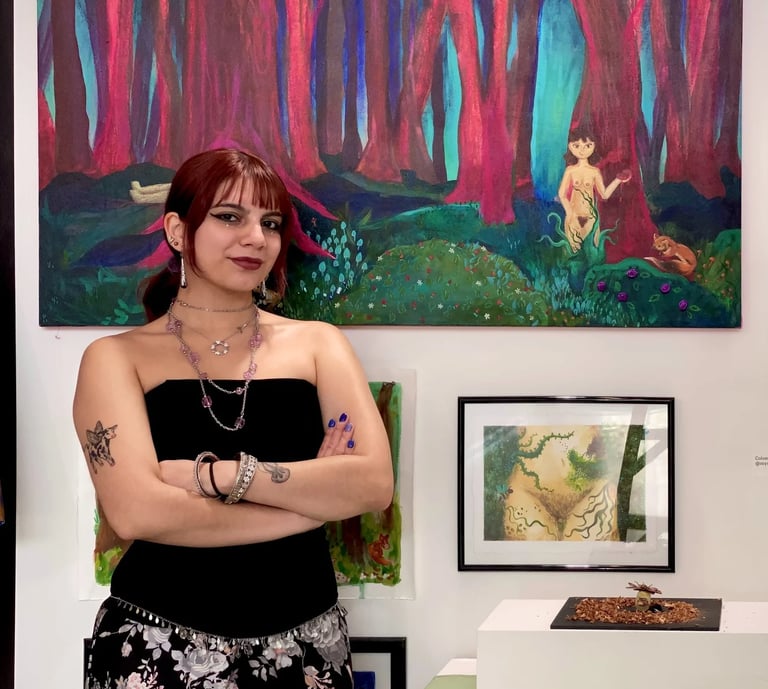 Artist with crossed arms posing in front of her colorful abstract forest paintings in a gallery.