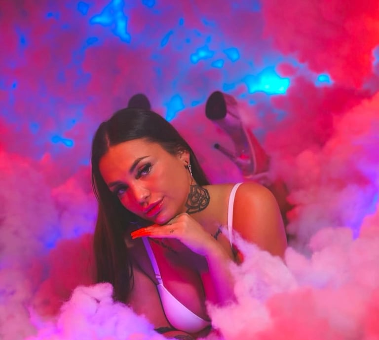 a woman in a white bra top and a pink smoke cloud