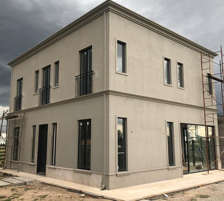 a house with a large window and a ladder