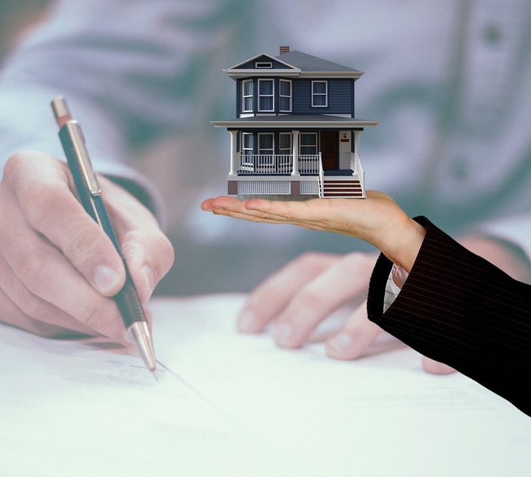a person holding a house model of a house