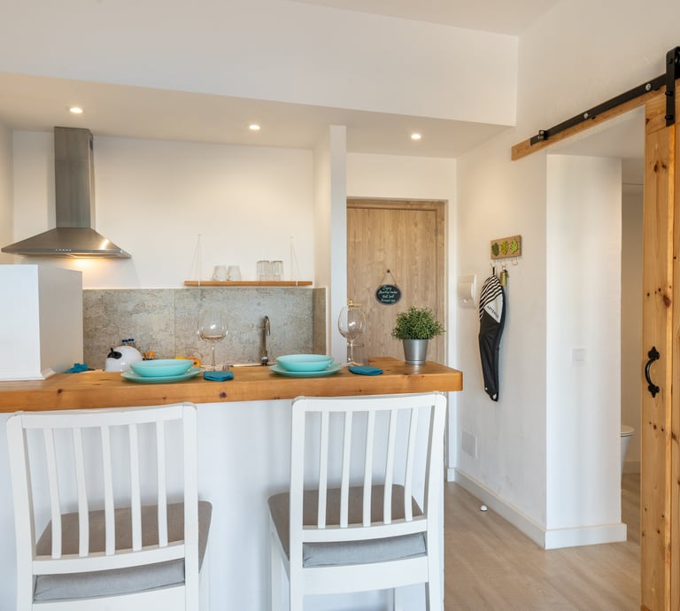 kitchen with American-style bar table and high wooden chairs