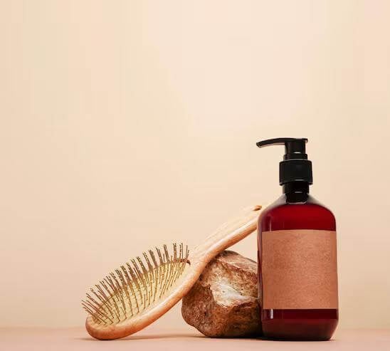 a hair brush and a bottle of hair