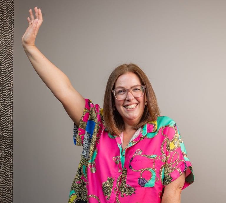 photo of gabi founder of the leopard mind smiling with arm in the air 