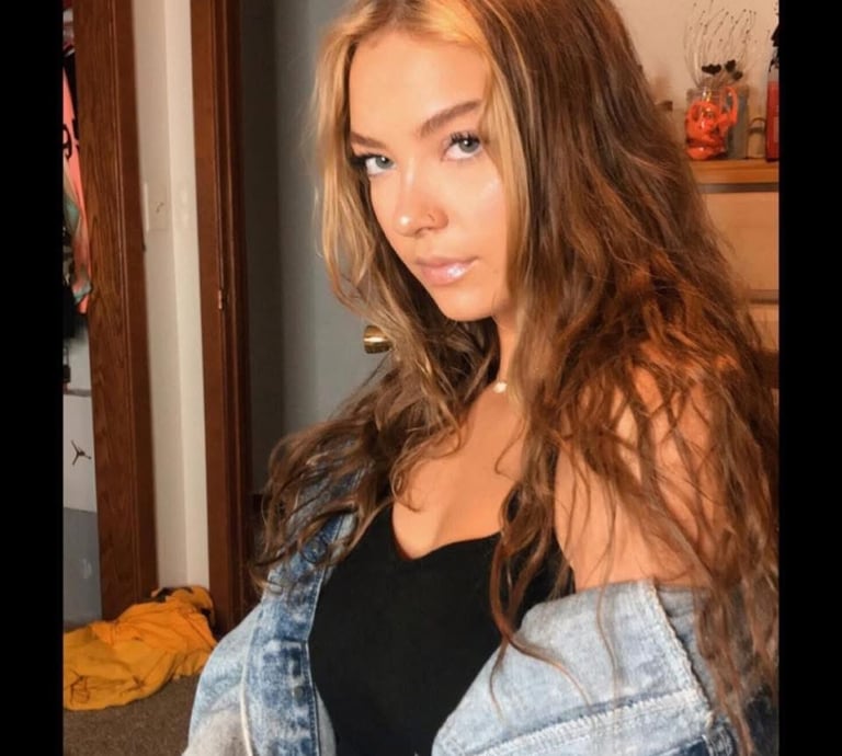 a woman with long hair and a denim jacket