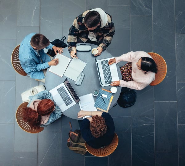 Students together around a table studying
