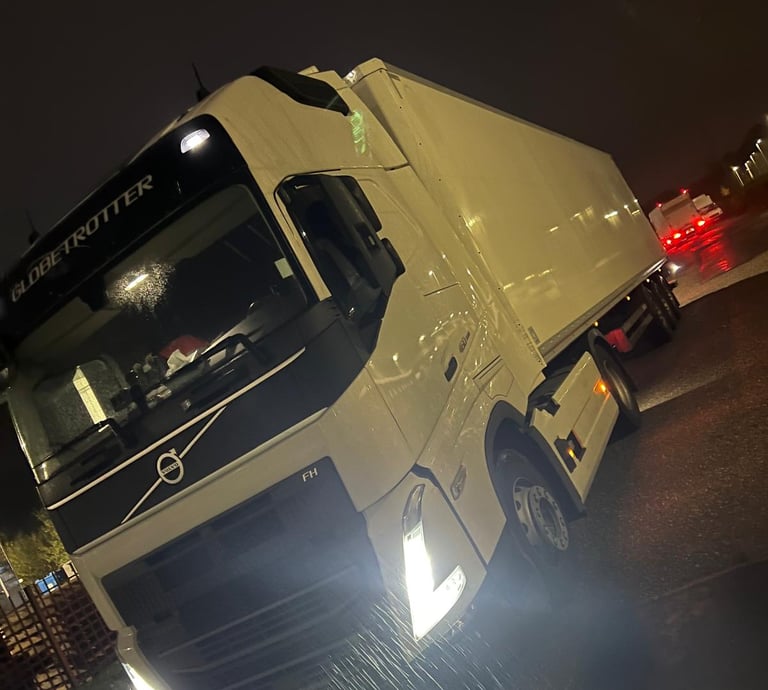 a truck with a white truck parked in front of it