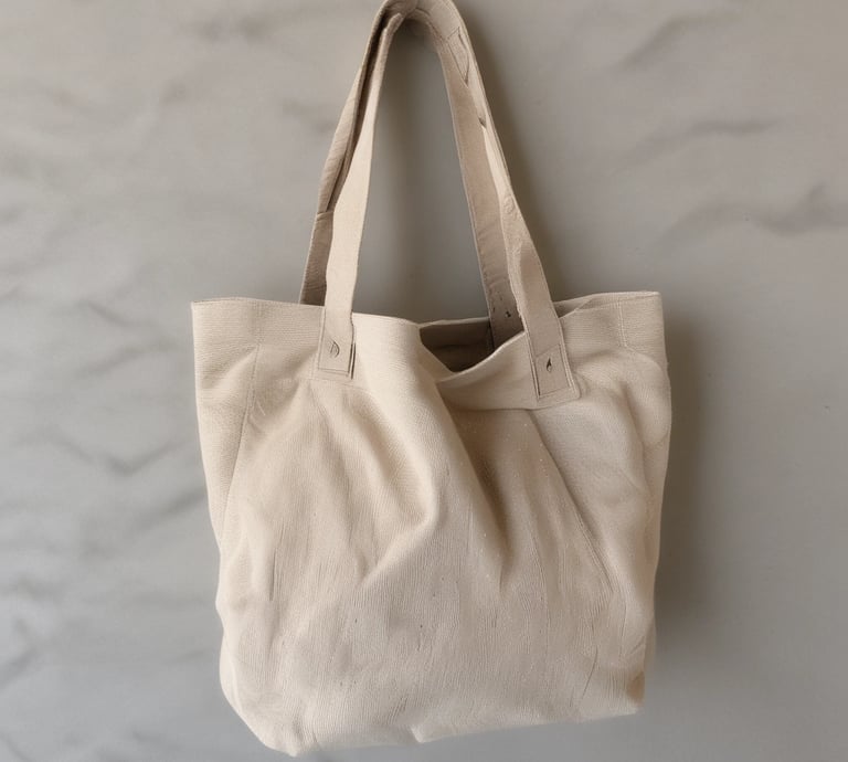 A close-up photo of a handmade French fabric tote bag with detailed stitching.