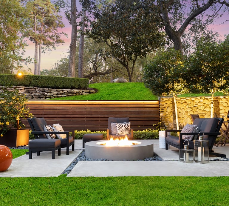 a patio with a fire pit and chairs