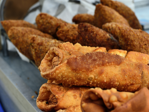 a tray of fried alcapurias and empanadas