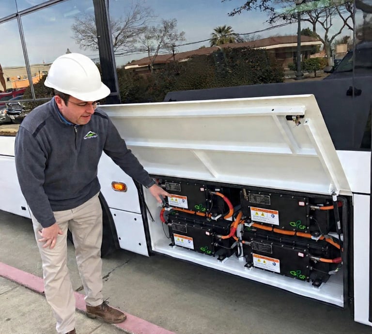 Technician showing the battery packs of a converted EV vehicle