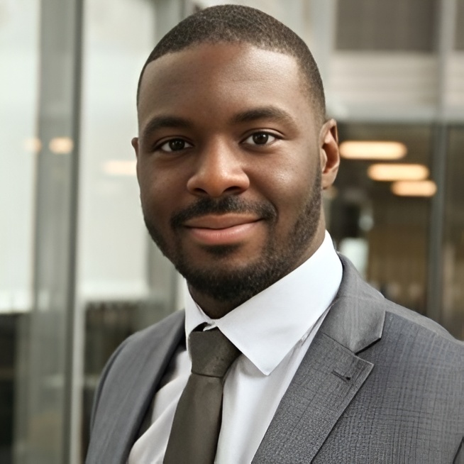 a man in a suit and tie smiling