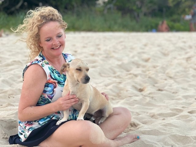Sunni Dawson smiling with a dog companion during animal communication session