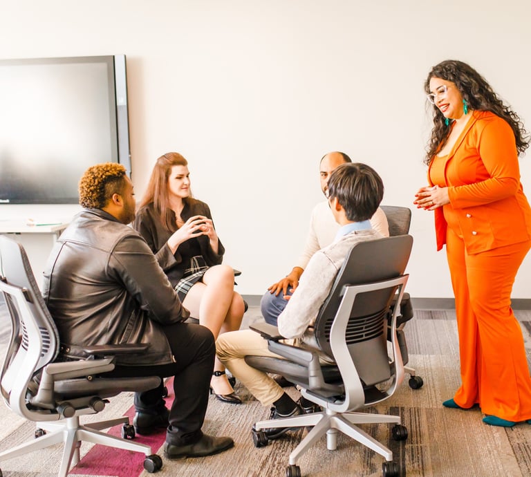 group of professionals sitting in a conference room with Betsaida LeBron