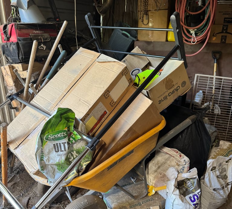 a wheelbarrowd cartonces in a garage