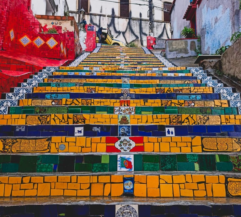 a staircase case with colorful painted steps leading up to a stairway, Selaròn, Rio de Janeiro
