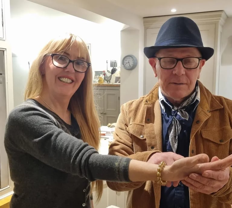 Rob Hamilton reading the palm of a female client