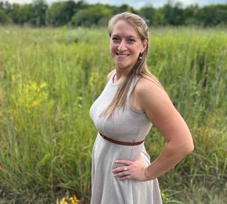 Lauren Witt in a dress standing in a field