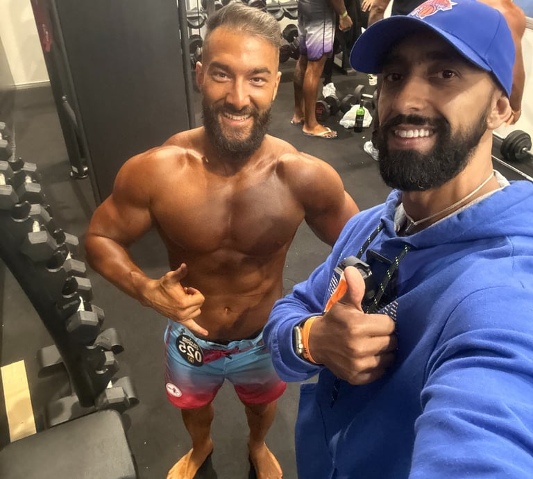 a man with a beard and a beard standing in a gym