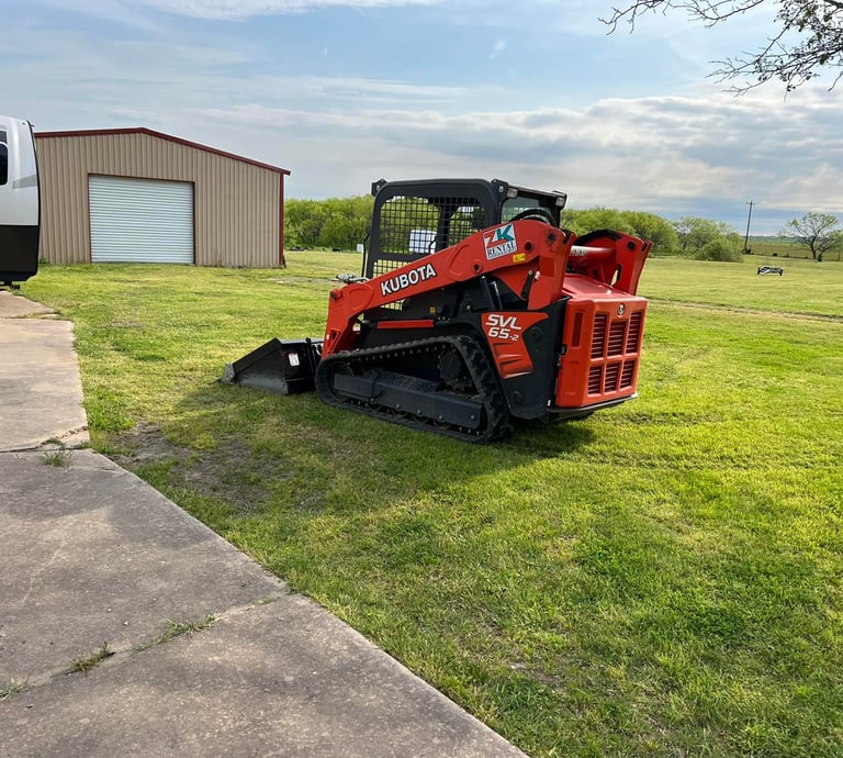 a skidsteer parked in the grass
