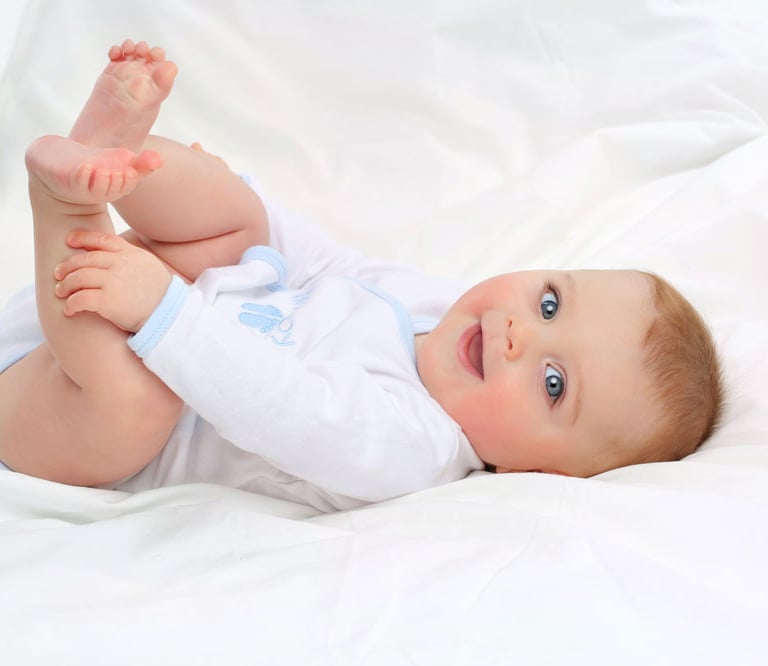 Smiling baby in organic babygrow